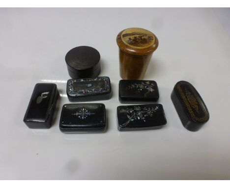 Six 19th century papier mache snuff boxes, four with inlaid mother-of-pearl decoration, a Mauchlinware cylindrical lidded pot