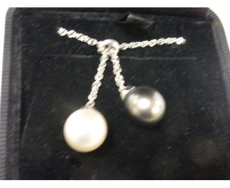 Pearl and diamond white gold pendant necklace, black and white pearls suspended from diamond set band, stated total diamond w