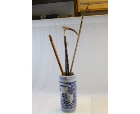 Four vintage walking sticks to include Antler handled and a Ceramic stick stand with Oriental design