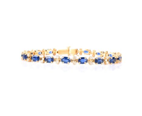 Vintage Oval Cut Synthetic Sapphire, Round Brilliant Cut Diamond and 14 Karat Yellow Gold Line Bracelet. Sapphire with vivid 