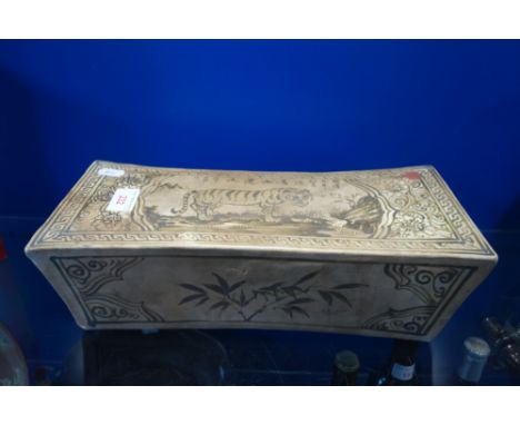 A CHINESE CERAMIC PILLOW, hand-painted with a tiger, 34.5cm long
