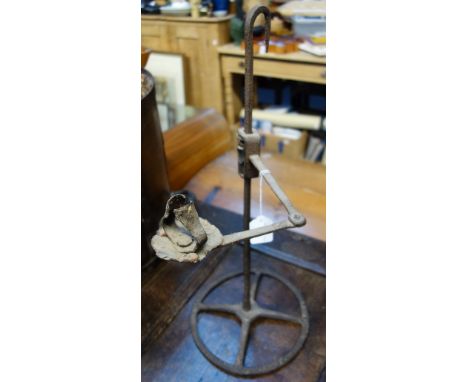 AN 18TH CENTURY IRON HANGING RUSH LIGHT HOLDER/CANDLE LAMP on circular base, 55cm high