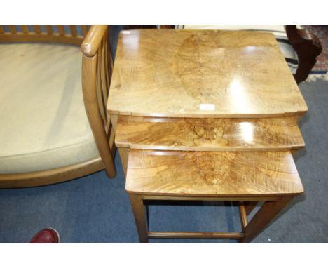 AN ART DECO NEST OF THREE WALNUT TABLES in the manner of Harry &amp; Lou Epstein, the largest 54cm wide