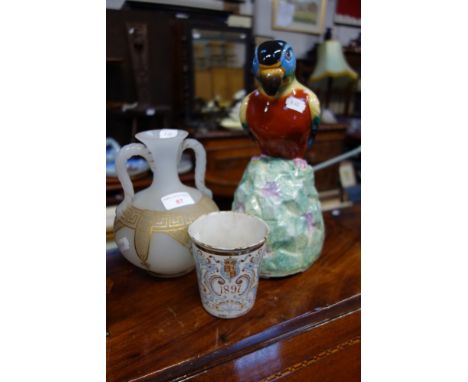 A VICTORIAN SATIN GLASS TWO HANDLED VASE with gilt Greek key decoration, an enamel 1897 beaker and a ceramic parrot