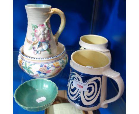 A CLARICE CLIFF JUG, decorated with flowers in relief, a Poole Pottery bowl and similar ceramics