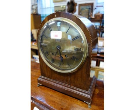 AN EDWARDIAN MAHOGANY MANTEL CLOCK with brass dial
