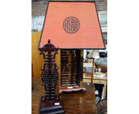 A CHINESE CARVED HARDWOOD TABLE LAMP, 36cm high (no fitting) and another Chinese table lamp made from Abacus