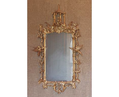 A giltwood mirror in the manner of Thomas Chippendale,late 19th century, carved with a pagoda top, leafy branches and ho-ho b