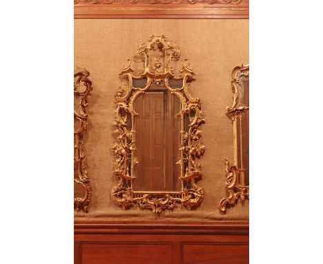 A George III giltwood mirror,c.1760, Irish, in the manner of Thomas Chippendale, with a later arched plate in shaped mirrored