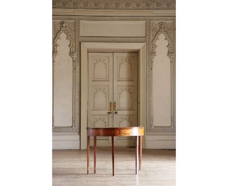 A George III satinwood card table with semi-elliptical top, inlaid with radiating veneers and amboyna scallops, the frieze wi