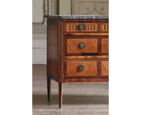 A Louis XVI tulipwood commode, the frieze inlaid with simulated fluting above two long drawers, on turned legs, surmounted by
