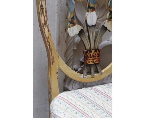 A pair of Sheraton-style painted shield-back chairs,19th century, each decorated with Prince of Wales feathers to a lined cre