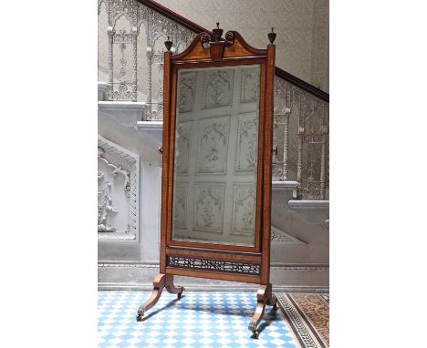 An Edwardian mahogany and satinwood Sheraton Revival cheval mirror,c.1910, with a break-arch swan-neck pediment surmounted by