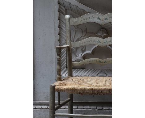 A painted ash ladder-back armchair,c.1880, finished in grey, with a rush seat, on stretchered legs,58cm wide51cm deep85cm hig