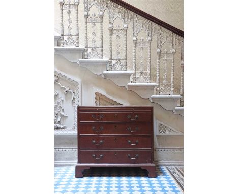 A George III mahogany chest of drawers,the caddy top, over a brushing slide and four graduated drawers, raised on bracket fee