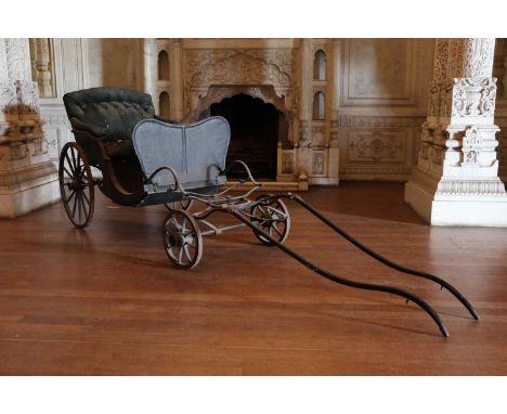 A pony phaeton,late 19th century, with an iron leaf sprung frame and button-upholstered seat,410cm long102cm wide122cm highCo