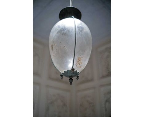 A porch lantern,early to mid-20th century, the ovoid glass shade suspended on a circular spreading iron boss,30cm diameter53c