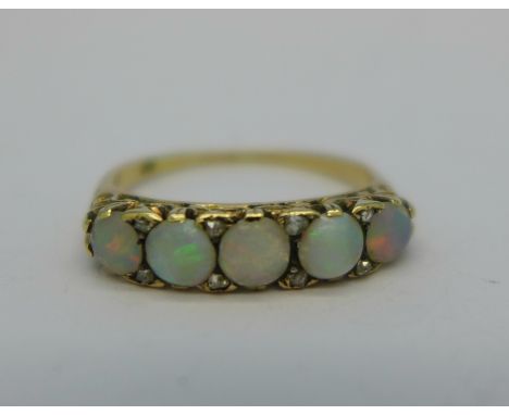 An 18ct gold five stone opal ring, set with eight small diamonds, 2.6g, O