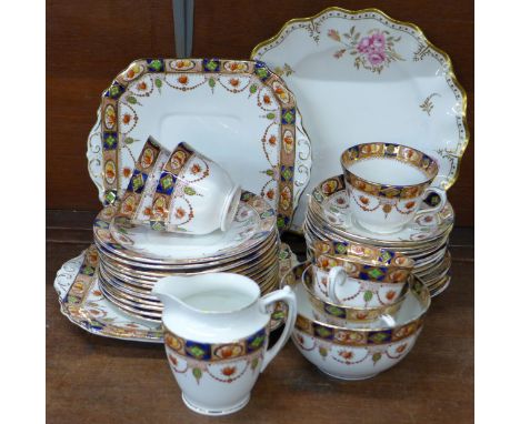 A Royal Crown Derby Royal Pinxton Roses plate and a decorative china tea service, thirty-three pieces in total