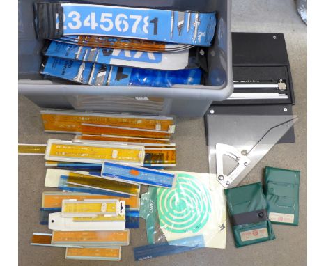 A collection of drawing office equipment including a Harling beam compass, brass stencils and a number of scale rulers