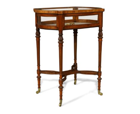 An Edwardian inlaid satinwood bijouterie table, early 20th century, the shaped hinged top with bevelled glass, enclosing a cr