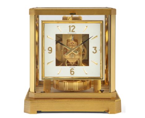 A Jaeger-LeCoultre 'Atmos' mantel clock, c.1977, the brushed brass case with five glass panels, the square white enamel dial 