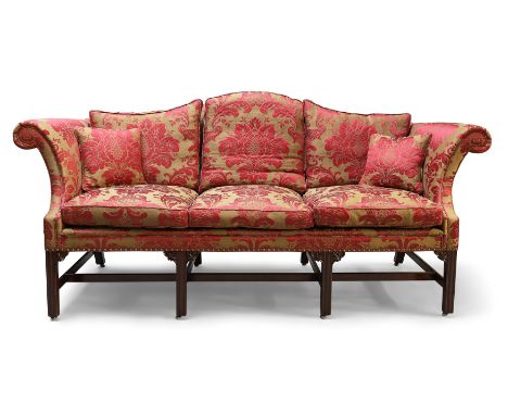 A George III mahogany camel back sofa, last quarter 18th century, with rouge damask upholstery, on chamfered legs and castors