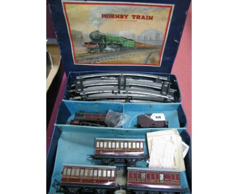 A Hornby 'O' Gauge No 501 Clockwork Passenger Train Set. 0-4-0 LMS loco R/No 5600,tender plus three LMS coaches, track and ke