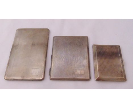 Three silver engine turned cigarette cases of rectangular form , approx total weight 484g