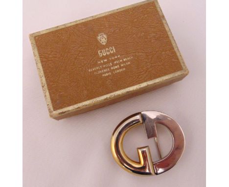 A vintage Gucci belt buckle in original Gucci packaging
