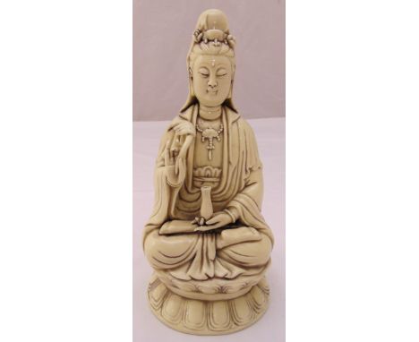 A Chinese ceramic seated figurine of Guanyin on raised shaped base, 26cm (h)