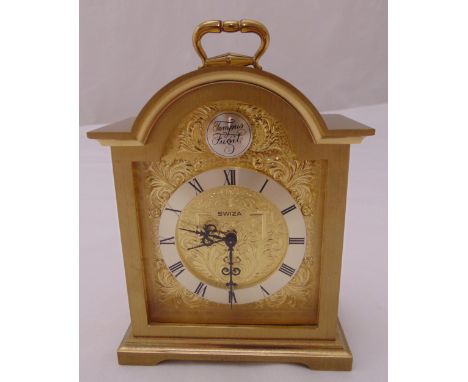Swiza gilt metal mantle clock with Roman numerals, carrying handle on four bracket feet, 16cm (h)