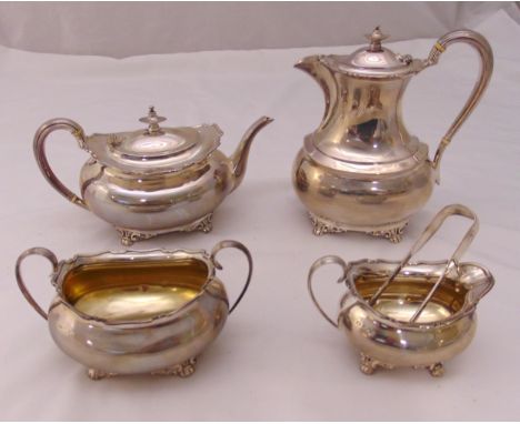 A hallmarked silver four piece teaset and a pair of sugar tongs of rounded rectangular form, the scroll handles raised hinged