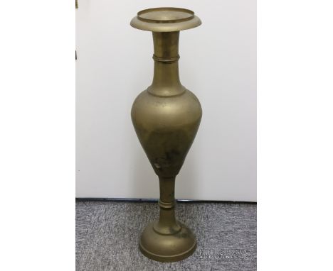 A large brass mosque vase, ovoid body with wide everted flared neck on socle base, 92cm high