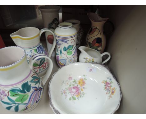 A collection of ceramics including Poole jugs and vase