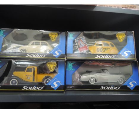 Four Solido 1:18 scale die-cast vehicles, all in window boxes