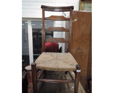 A 19th century stained frame church chair having ladder back and seagrass seat