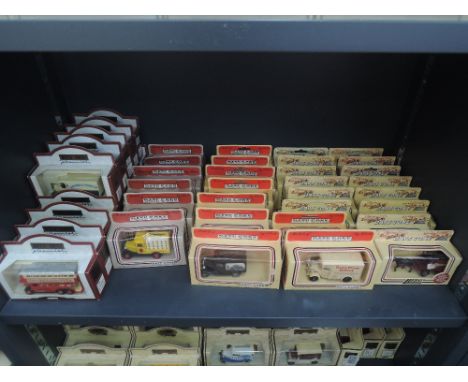 A shelf of Lledo Days Gone By die-cast vehicles in red and straw window boxes, approx 40