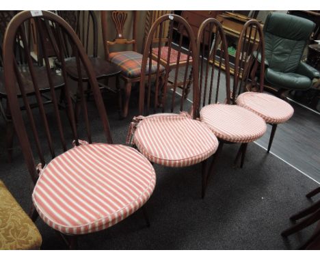 A set of four dark Ercol hoop and stick back kitchen chairs