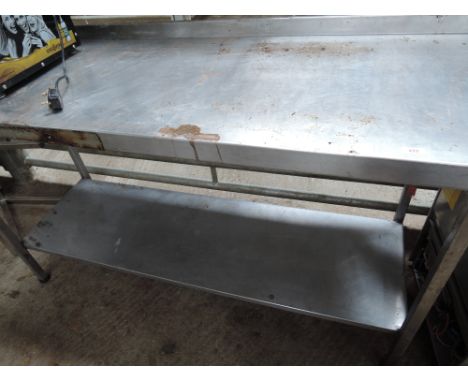 A stainless steel prep table 63'x24' with shelf