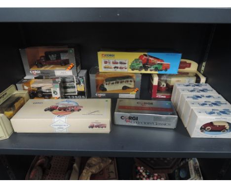 A shelf of modern Corgi and Lledo die-casts including buses and wagons, all boxed