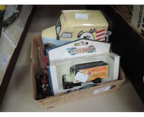 A selection of toy cars , including ceramic money box and boxed Lledo car