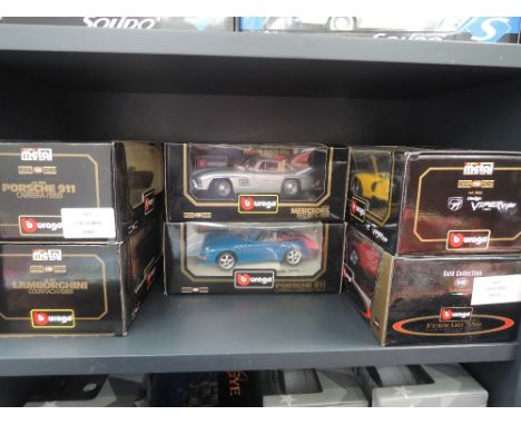 Seven Burago 1:18 scale vintage and sports cars, all in window boxes