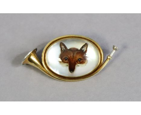 A Tiffany &amp; Co yellow &amp; white-metal novelty hunting horn brooch inset with Essex crystal fox portrait, 4.5cm wide.