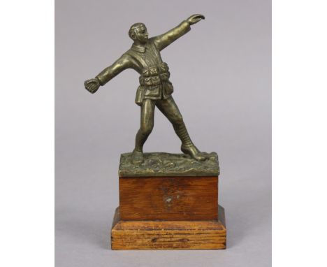 A bronzed sculpture of a WWI standing soldier figure throwing a grenade, signed to reverse “Sydney Wilkinson” mounted on a wo