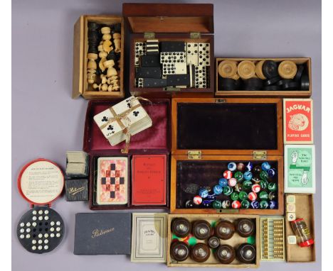 A set of carved treen travelling chessmen (size of kings 5.75cm high); a set of dominoes; a set of draughtsmen, all cased; va