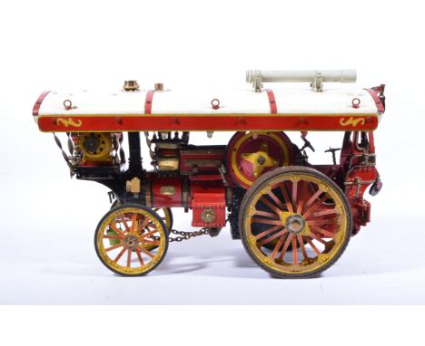 A well engineered scratch built red, cream and yellow painted model of a traction engine, powered by a Lucas electric motor, 