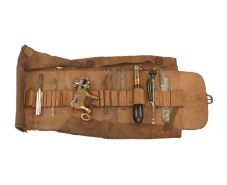 A HOLTZAPFFEL tool roll containing the tool handle a few orig tools and an exquisite brass and steel table clamp almost certa