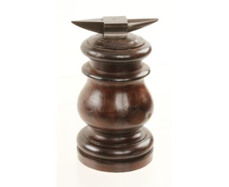 A watchmakers 4" anvil set in turned mahogany plinth 7"h G+