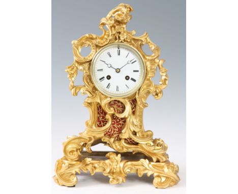 A LATE 19th CENTURY FRENCH ROCOCO STYLE ORMOLU MANTEL CLOCK the case with cast leaf work decoration enclosing a 3.5&rdquo; en